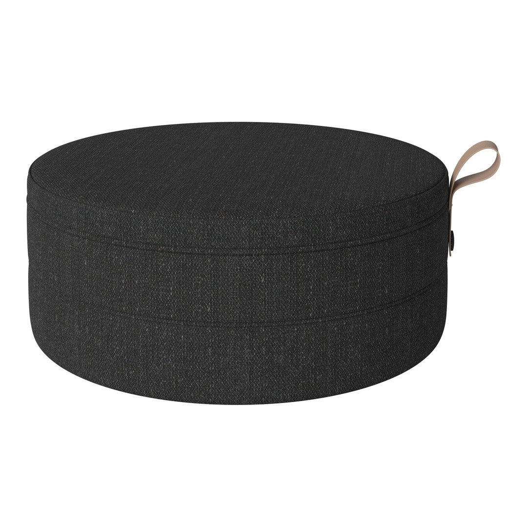 Round black fabric cushion with a textured pattern, featuring a subtle loop handle for easy carrying.