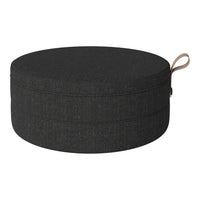 Round black fabric cushion with a textured pattern, featuring a subtle loop handle for easy carrying.
