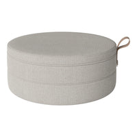 Light gray round pouf with a subtle textured pattern and practical carry handle.