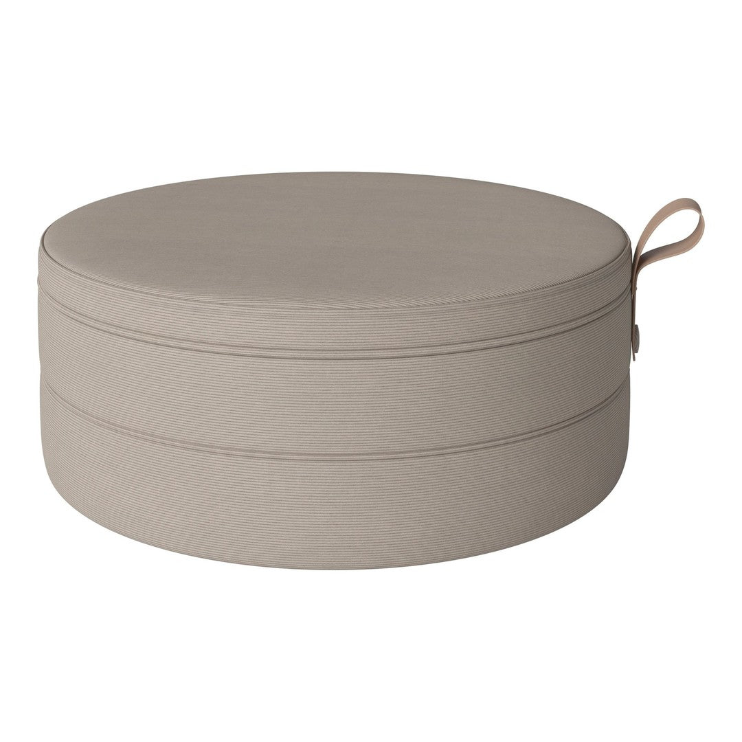 Round beige pouf with a smooth texture and subtle stitching detail. Ideal for modern decor.