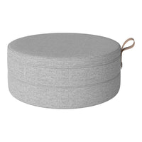 Gray round storage pouf with a textured fabric surface and a stylish loop handle. Perfect for modern decor.