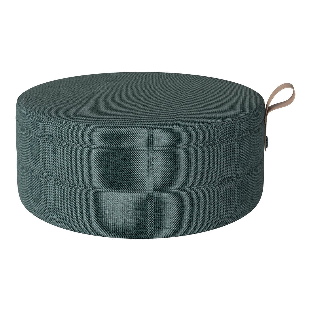 Round teal storage ottoman with textured fabric and a stylish handle for easy transport. Perfect for modern decor.