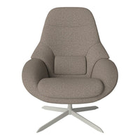 Soft beige fabric armchair with smooth contours, featuring a minimalist design and a silver base. Perfect for modern decor.
