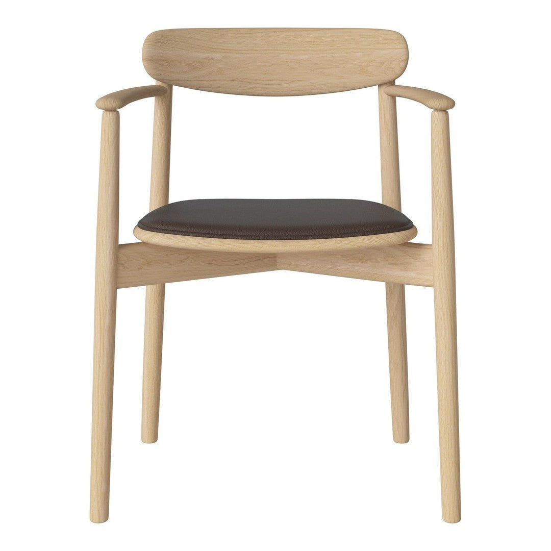 Light wood chair with a minimalist design and a sleek black seat cushion, showcasing a modern aesthetic.