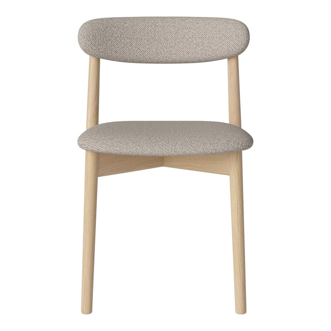 Beige textured fabric chair with light wooden legs, featuring a minimalist design and contemporary style.