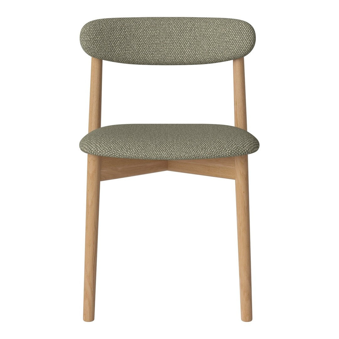 Green upholstered chair with rounded backrest and natural wood legs, featuring a smooth, textured fabric pattern.