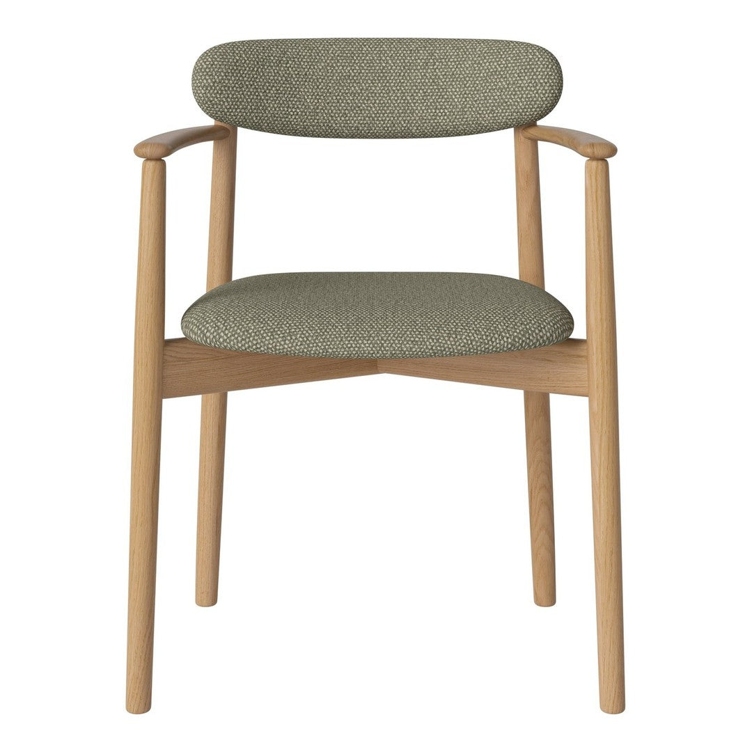 Green patterned upholstery chair with natural wood frame, perfect for modern interiors.