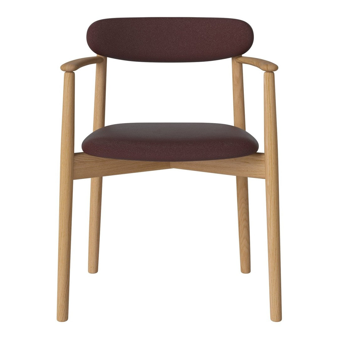 Burgundy upholstered chair with natural wood frame; minimalist design with clean lines and subtle elegance.