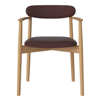 Burgundy upholstered chair with natural wood frame; minimalist design with clean lines and subtle elegance.
