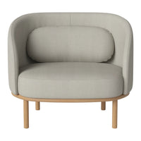 Light gray upholstered armchair with rounded shapes and a natural wood base. Soft, minimalist design for modern decor.