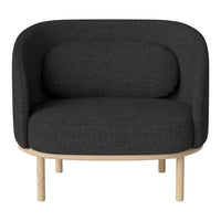 Gray upholstered armchair with a minimalist design, featuring a rounded shape and natural wood legs.