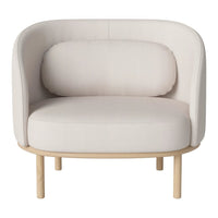Cream-colored upholstered chair with a rounded shape and minimalist design, featuring a light wood base.