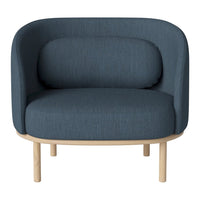 Blue upholstered chair with a smooth texture and rounded back, complemented by natural wood legs.