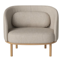 Beige upholstered chair with a curved back and rounded cushions, featuring a smooth, minimalistic design.