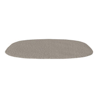 Neutral beige oval rug with a subtle textured pattern, perfect for complementing various interior styles.