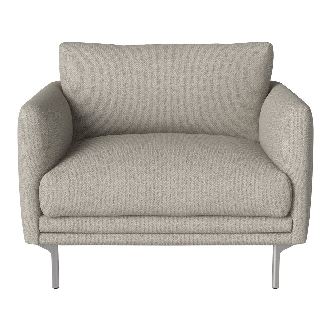 Light beige armchair with a smooth texture and minimalist design, featuring plush cushions and silver metal legs.
