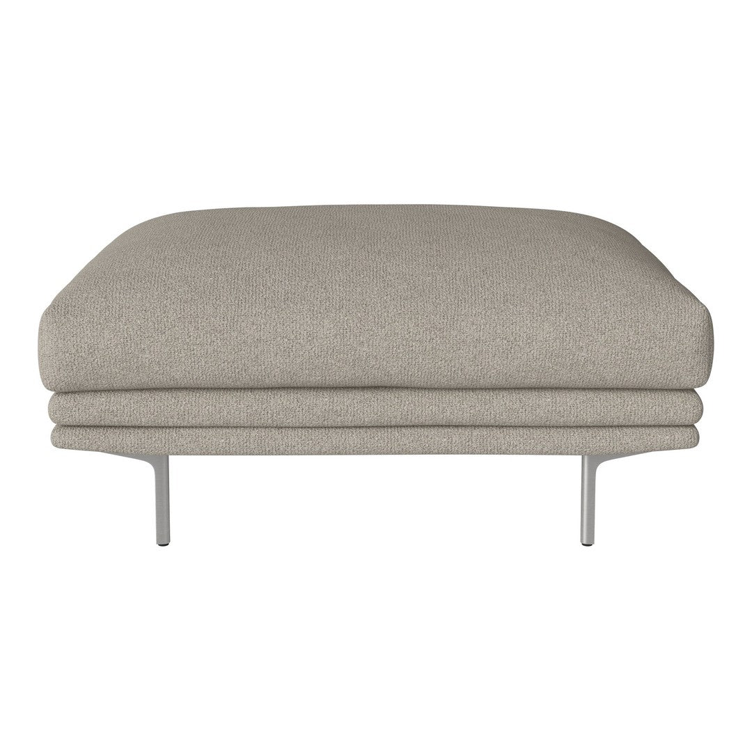 Beige upholstered ottoman with a smooth, curved silhouette and sleek metal legs, perfect for modern decor.