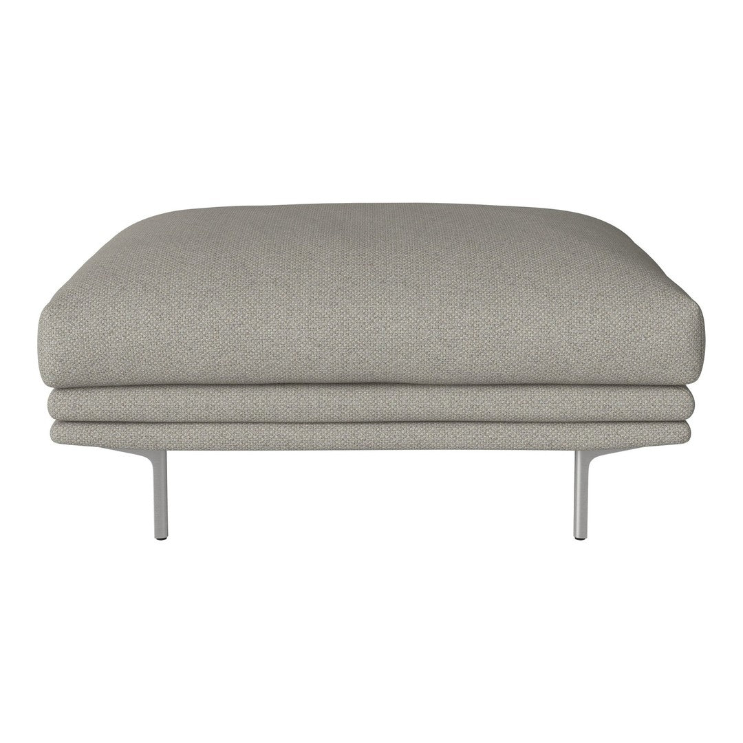 Gray upholstered ottoman with a smooth, minimalist design and subtle texture, supported by sleek metal legs.