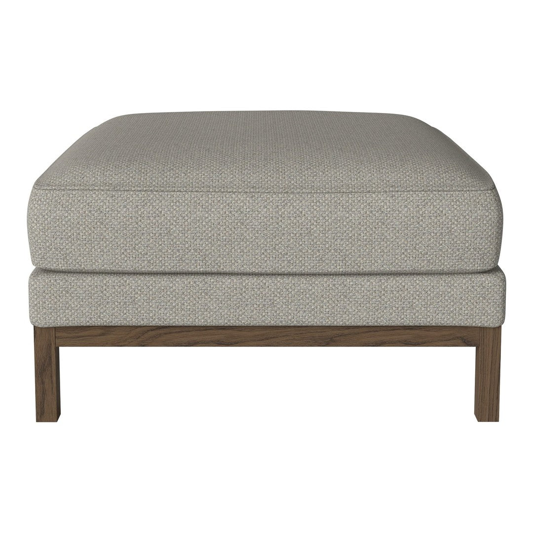 Gray upholstered ottoman with a subtle textured pattern and a wooden base. Ideal for modern home decor.