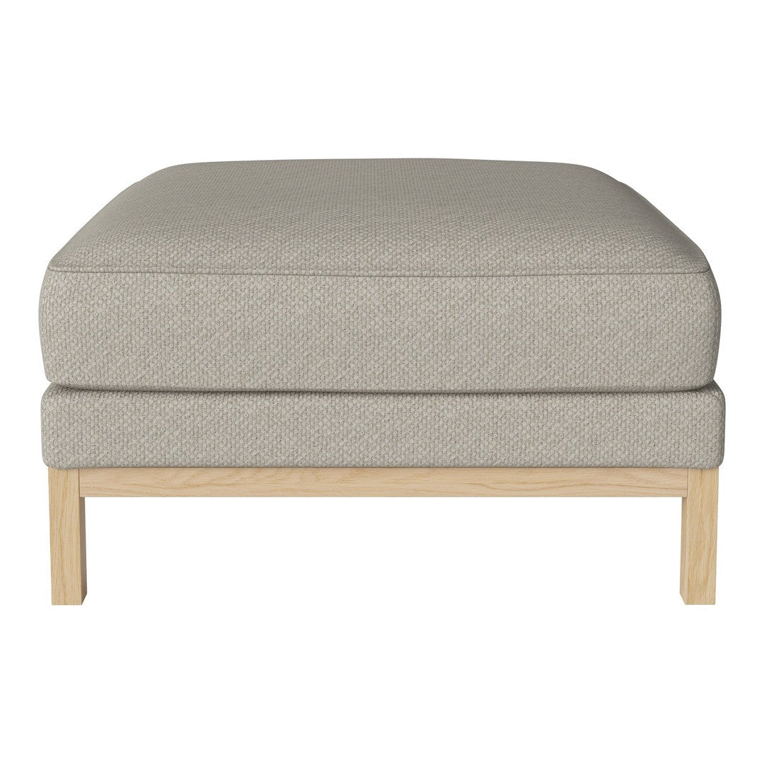 Light gray cushion ottoman with a textured fabric and natural wood frame. Simple, modern design fits any decor.