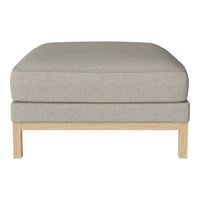 Light gray cushion ottoman with a textured fabric and natural wood frame. Simple, modern design fits any decor.