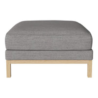 Gray upholstered ottoman with clean lines and a light wood frame. Modern design for versatile decor.