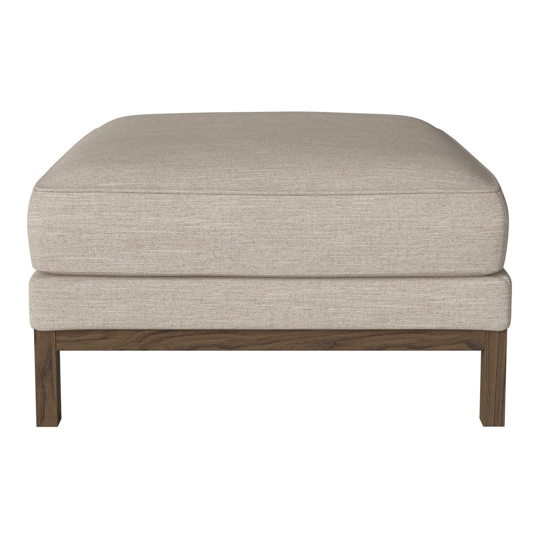 Beige upholstered ottoman with a smooth, minimalist design and wooden legs, perfect for versatile home decor.
