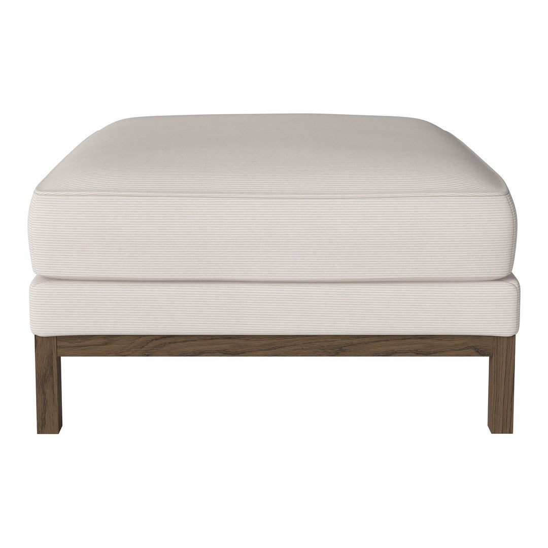 Cream ottoman with a smooth, solid surface and a contrasting dark wood frame. Ideal for modern decor.