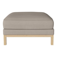 Light beige upholstered ottoman with a smooth, soft surface and natural wood legs. Simple, modern design.