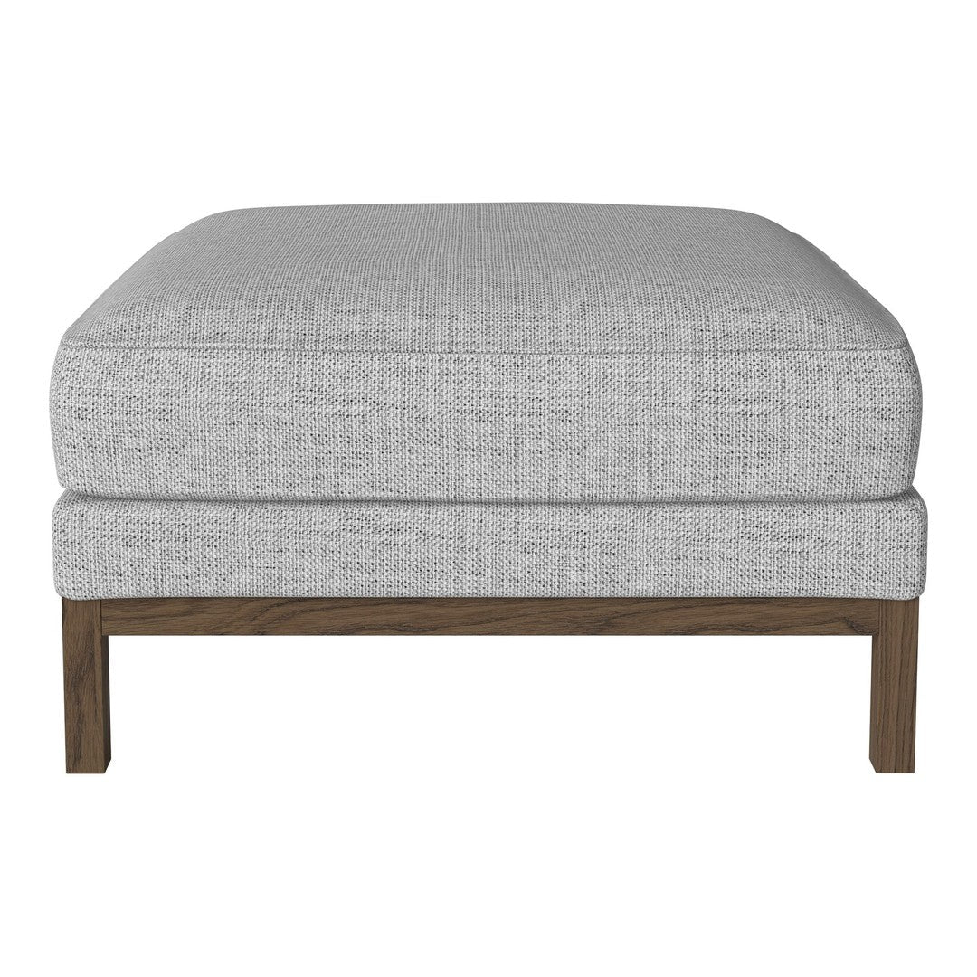 Light gray upholstered ottoman with a smooth fabric texture and a dark wood frame. Perfect for modern decor.