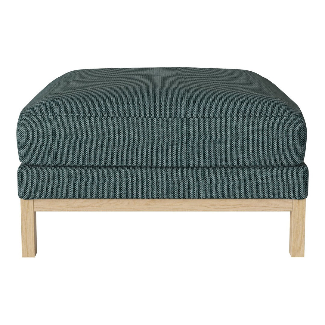 Teal upholstered ottoman with a textured pattern and natural wood legs, perfect for modern decor.