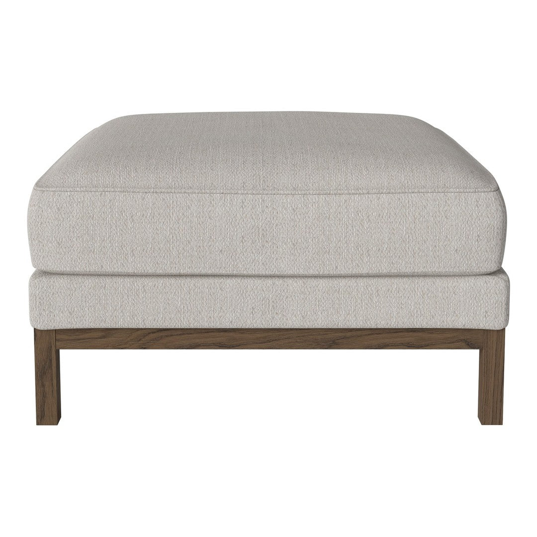 Light grey upholstered ottoman with a smooth texture and wood legs, perfect for modern decor.