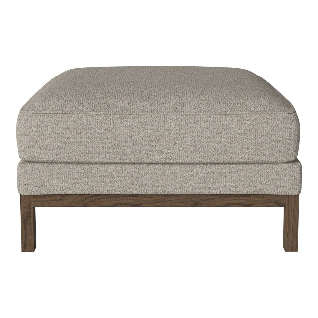 Beige upholstered ottoman with a smooth texture and wooden base, perfect for versatile home decor.