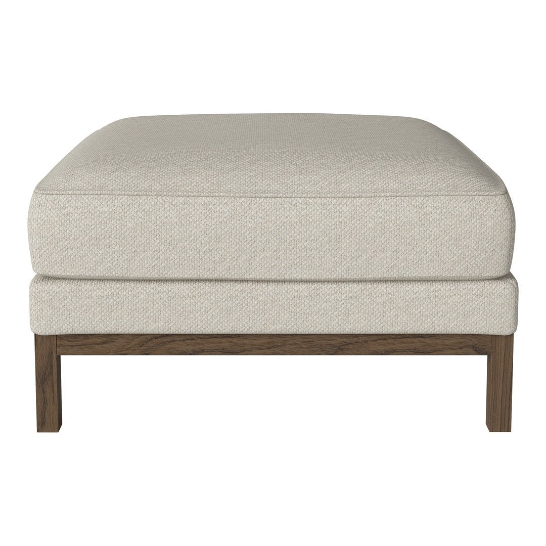 Beige upholstered ottoman with a smooth texture and a wooden base, perfect for modern decor.