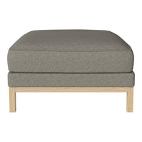 Gray upholstered ottoman with a smooth texture and light wood legs. Modern, minimalist design ideal for any decor.