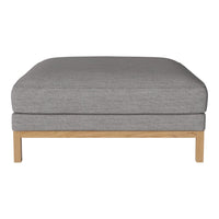 Gray linen ottoman with a smooth texture and light wooden legs, perfect for modern living spaces.