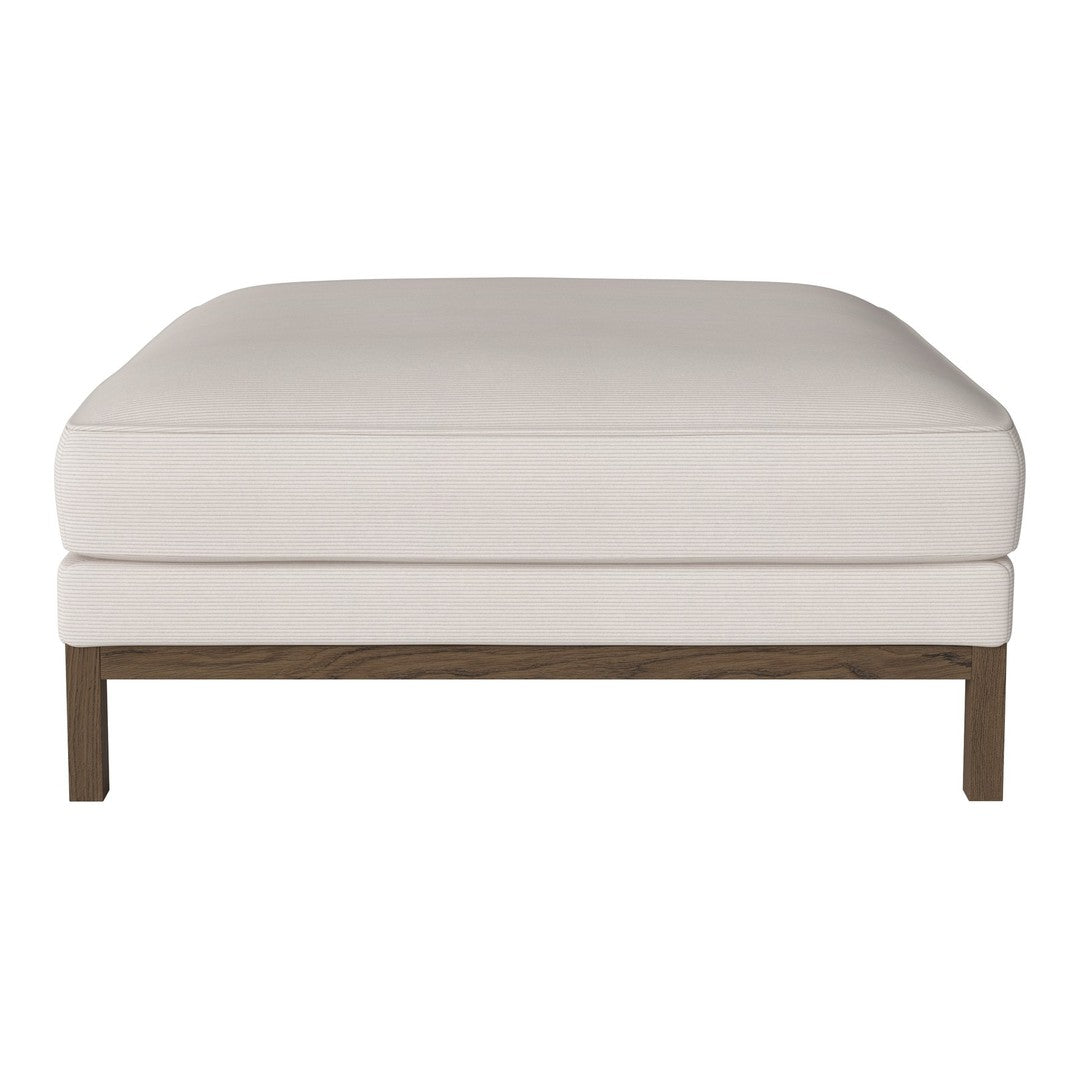 White upholstered ottoman with a smooth surface and a dark wood base, showcasing a minimalist design.