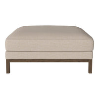 Beige upholstered ottoman with a simple, textured surface and a wooden base. Perfect for any modern decor.