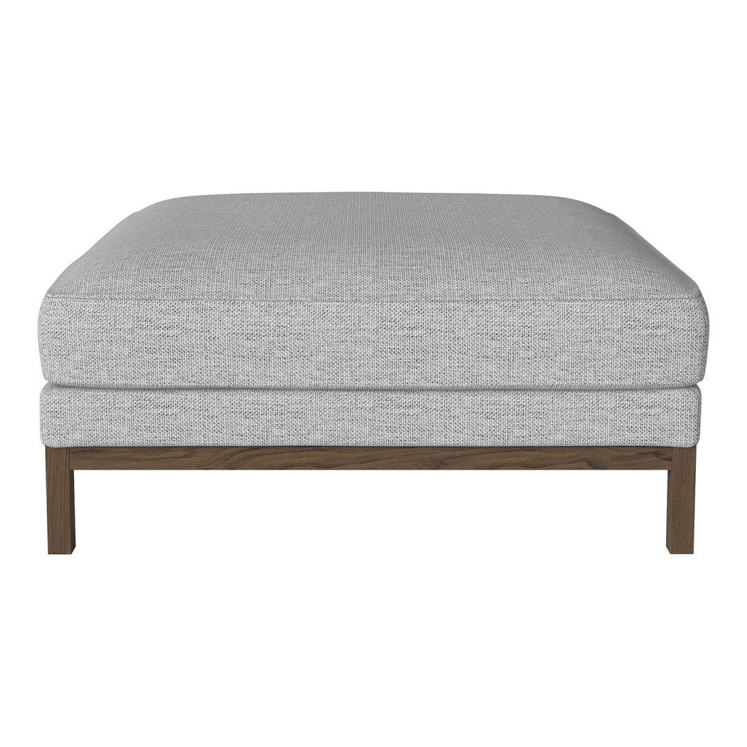 Gray upholstered ottoman with a smooth texture and brown wooden legs, perfect for modern decor.