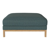 Teal upholstered ottoman with a textured pattern and light wooden legs, adding a modern touch to any space.