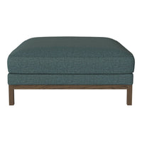 Teal upholstered ottoman with a simple, textured pattern and a wooden base, perfect for modern living spaces.