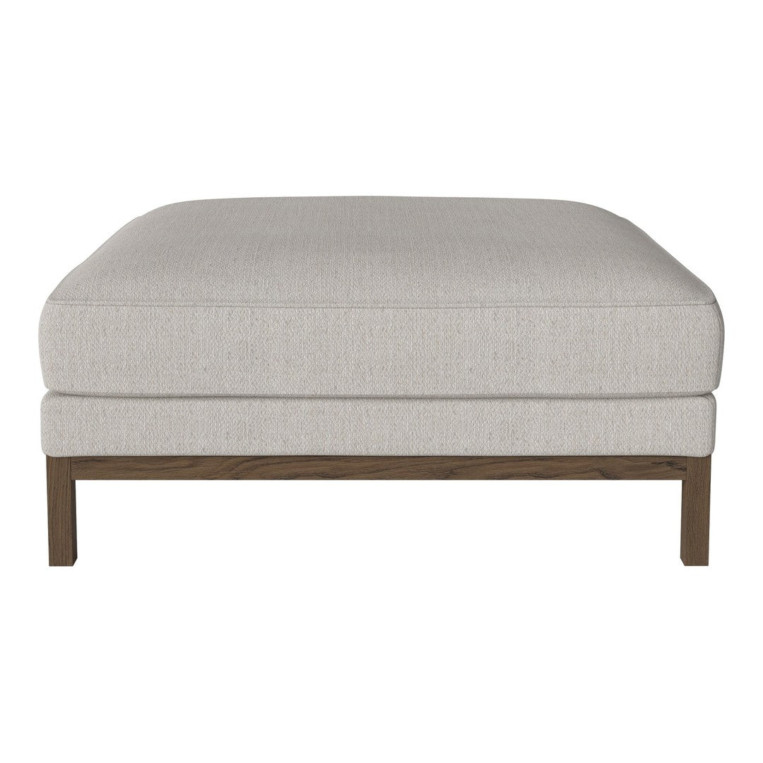 Light beige upholstered ottoman with a smooth texture and wooden legs, featuring a simple and modern design.