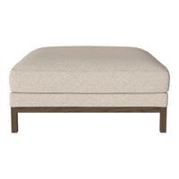 Beige upholstered ottoman with a textured finish and wooden legs, providing a neutral and versatile accent.
