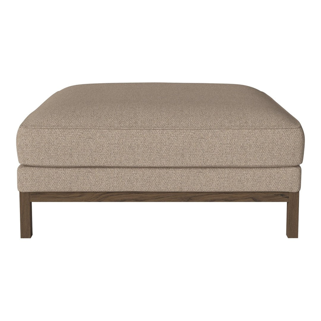 Beige upholstered ottoman with a smooth texture, featuring a dark wood frame for a modern touch.