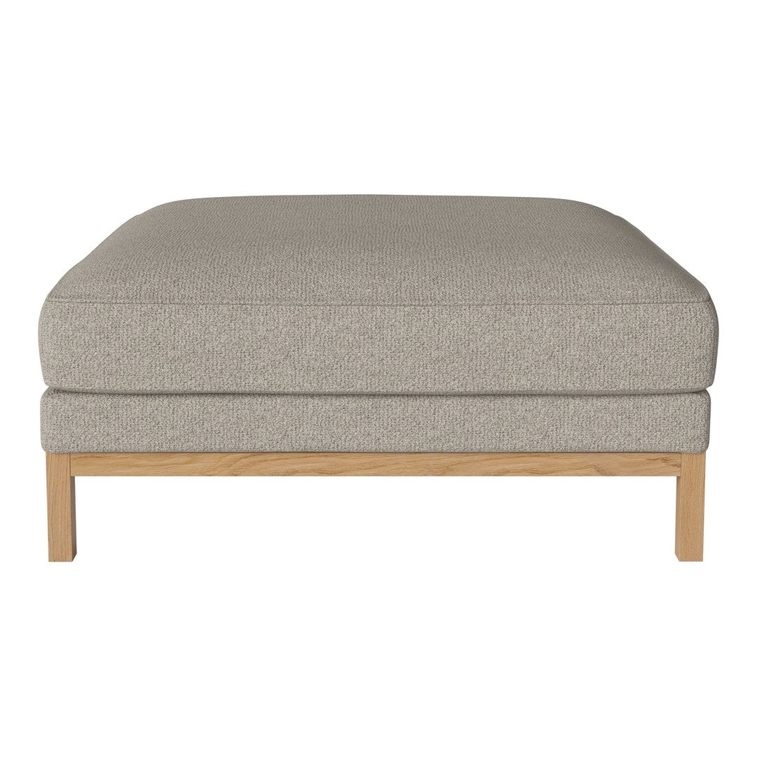 Gray upholstered ottoman with a smooth texture and light wooden legs. Modern, minimalist design for versatile decor.