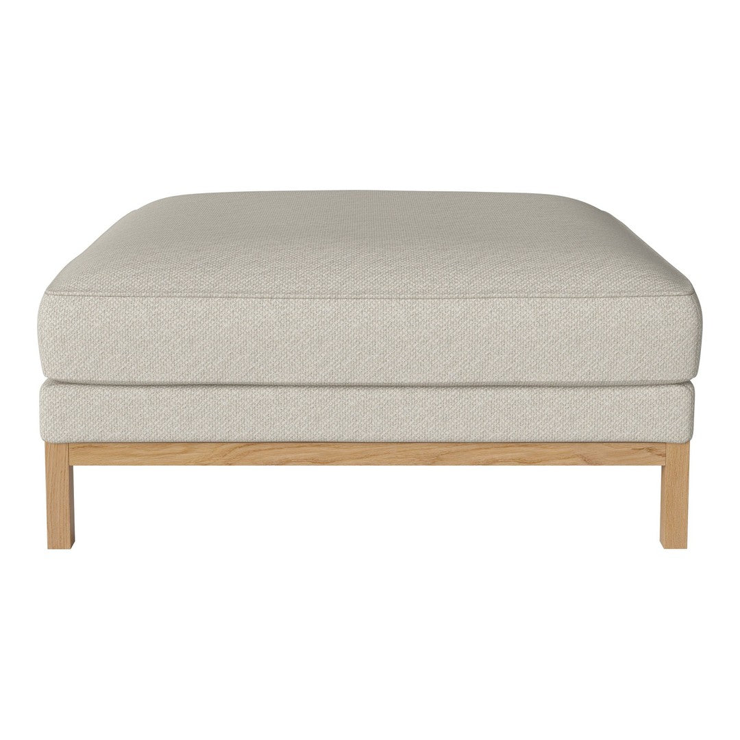 Light beige upholstered ottoman with a smooth texture and natural wood legs, perfect for a modern living room.