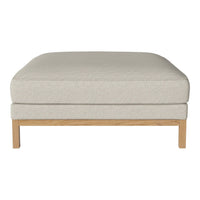 Light beige upholstered ottoman with a smooth texture and natural wood legs, perfect for a modern living room.