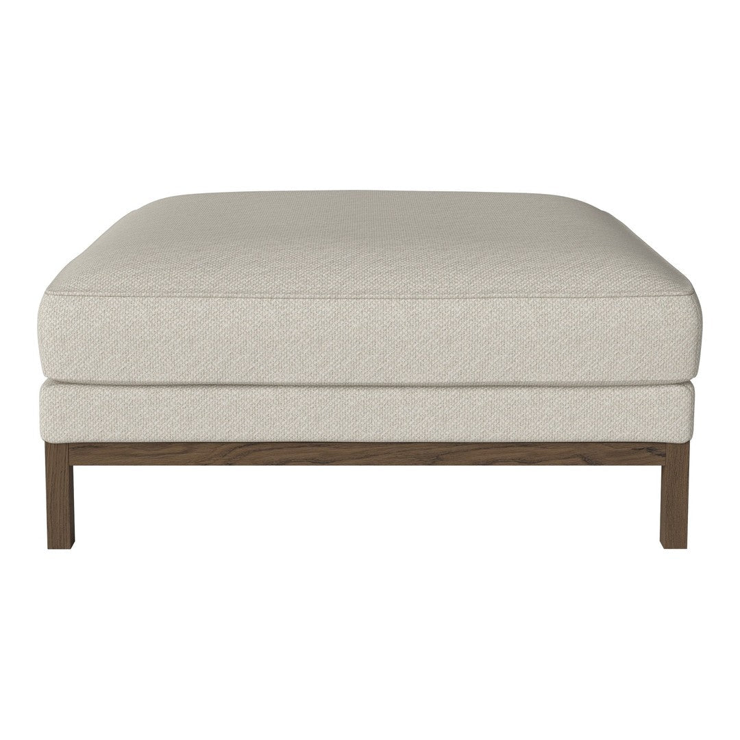 Beige upholstered ottoman with a subtle textured pattern and wooden legs, perfect for modern living spaces.