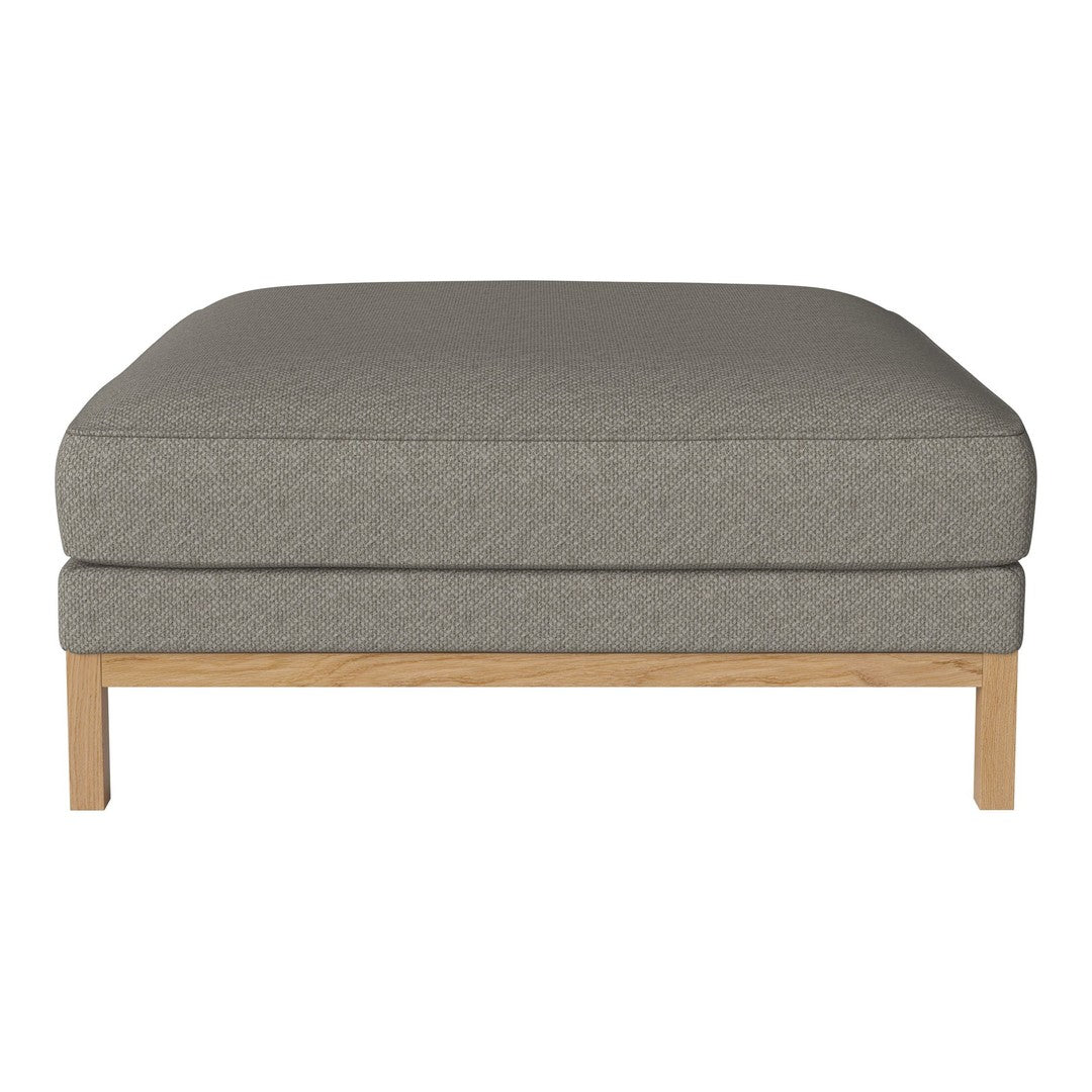 Gray upholstered ottoman with a smooth fabric texture and light wood legs, featuring a minimalist design.