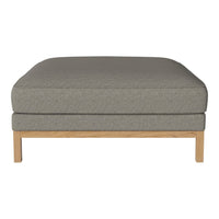 Gray upholstered ottoman with a smooth fabric texture and light wood legs, featuring a minimalist design.